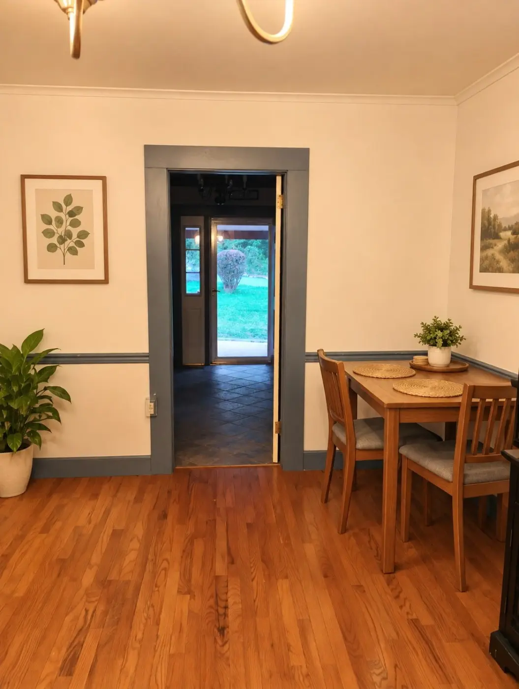 Temporary staged dining nook with table and warm wood floor