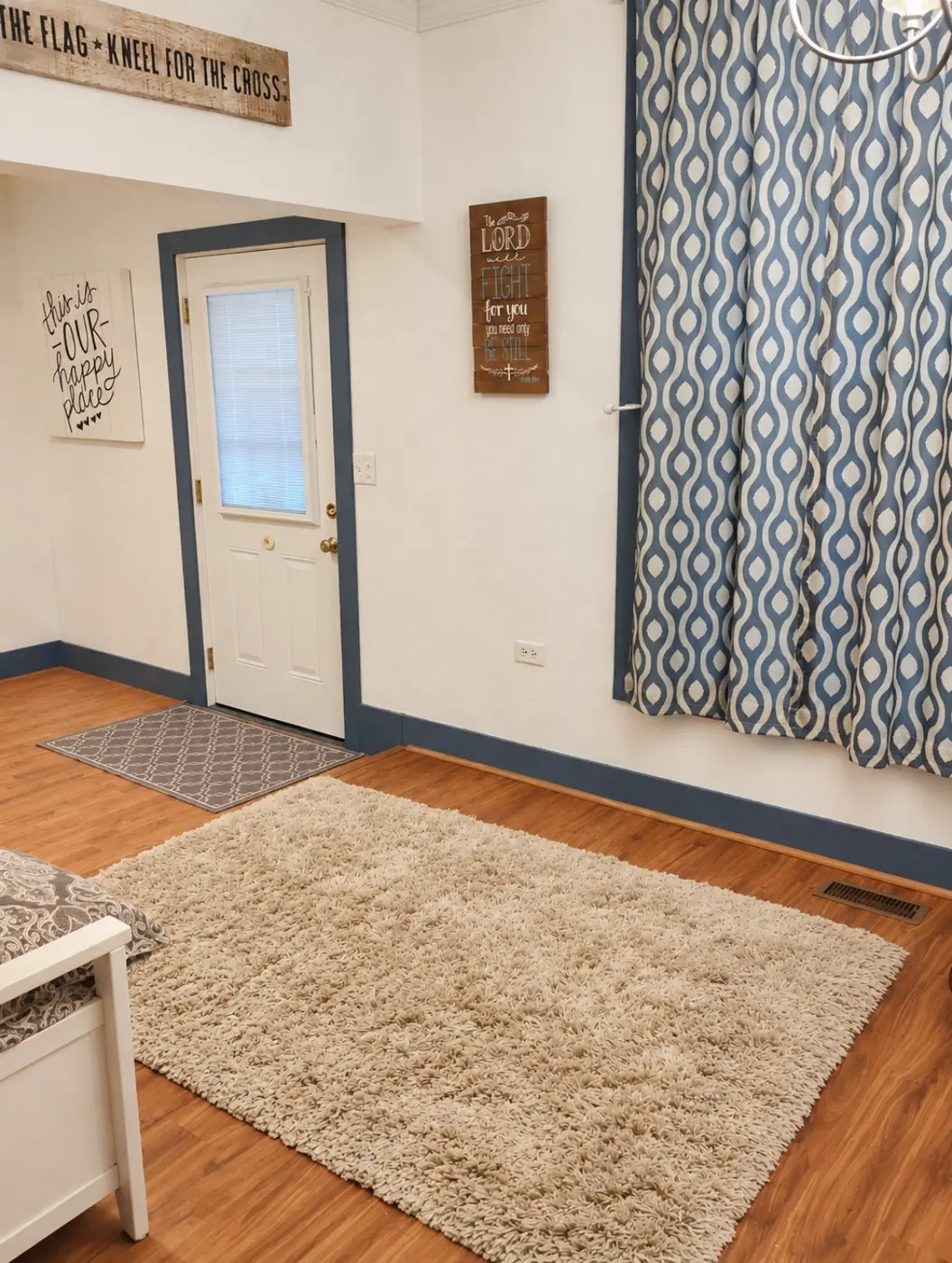 Temporary staged entry sitting area with rug and curtains